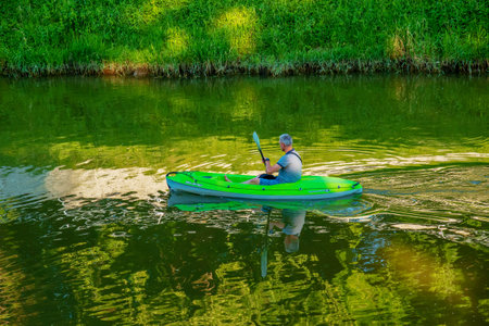 Nitra, Slovakia - 06.15.2022: A middle-aged man is sailing in a canoe on the Nitra river.のeditorial素材