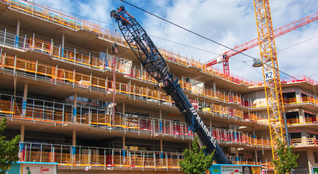 Vienna, Austria - 06.13.2022: Crane and construction site against blue skyのeditorial素材