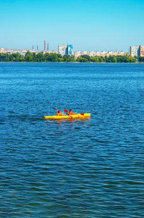 Dnepropetrovsk, Ukraine - 09.11.2021: Athletes in kayaks in training near the river fountain in a rainbow of splashes.の写真素材