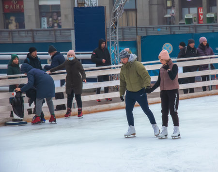 Dnipro, Ukraine - 02.10.2022: People have fun skating on a public ice rink built by the municipality on the streets of the city during Christmasの写真素材