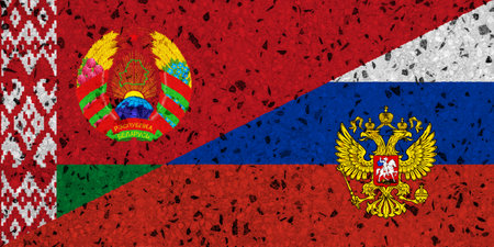 Flags of Russia and Belarus on a stone wall. Concept of cooperation between two countriesの写真素材