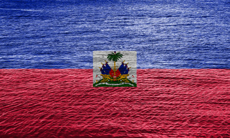 Flag of the Republic of Haiti On the texture of the surface of the water with small ripples.の写真素材