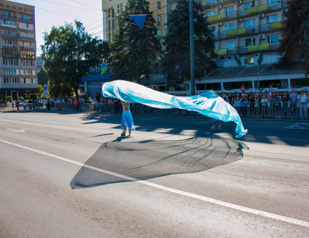 Dnipro, Ukraine - 09.11.2021: Citizens celebrate City Day. Rollerblading dancers waving the flag.のeditorial素材