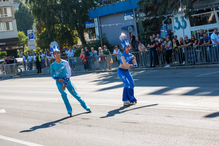 Dnipro, Ukraine - 09.11.2021: Citizens celebrate City Day. Rollerblading dancers waving the flag.のeditorial素材