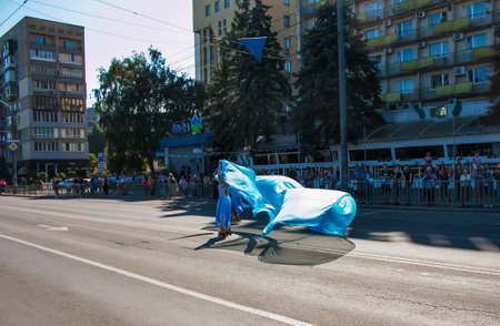 Dnipro, Ukraine - 09.11.2021: Citizens celebrate City Day. Rollerblading dancers waving the flag.のeditorial素材