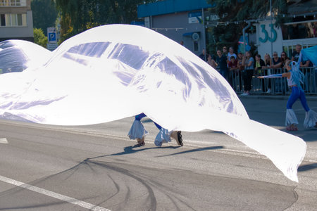 Dnipro, Ukraine - 09.11.2021: Citizens celebrate City Day. Rollerblading dancers waving the flag.のeditorial素材