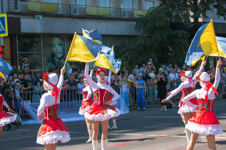 Dnipro, Ukraine - 09.11.2021: Citizens celebrate City Day. Girls dancers with waving flags of Ukraine.のeditorial素材