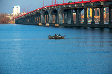 Dnieper river, Dnepropetrovsk, Ukraine - 11.13.2021: Fishermen on a boat on the river catch fish in autumn. Fishing is a special kind of sport.のeditorial素材