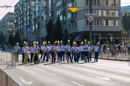Dnipro, Ukraine - 09.11.2021: Citizens celebrate City Day. An orchestra of musicians with wind instruments dressed as hussars on a city street.のeditorial素材