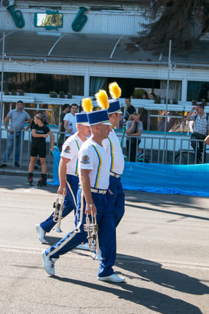 Dnipro, Ukraine - 09.11.2021: Citizens celebrate City Day. An orchestra of musicians with wind instruments dressed as hussars on a city street.のeditorial素材