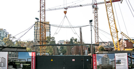 Dnipro, Ukraine - 10.22.2022: Unloading reinforcement for concrete work by a crane from a truck. Residential building constructionのeditorial素材