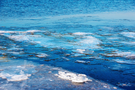 Ice surface of the river. The texture of fragments of ice and water during the icing period. winter...