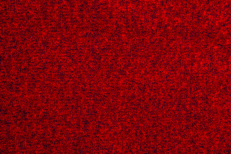 Red knitted wool Christmas background. warm sweater atmosphere. christmas wallpaper. Texture of woolen or acrylic jersey. Basis for winter designの写真素材