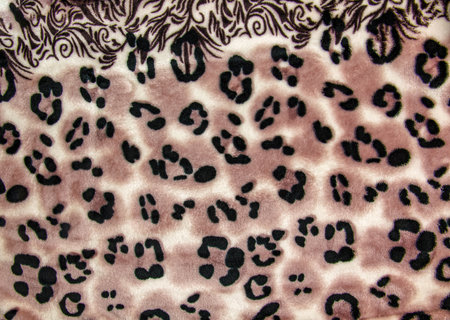 Close-up pattern of fleece fabric with leopard pattern. Brown-beige and black striped repeating on the surface of fur clothes, abstract texture background.の写真素材
