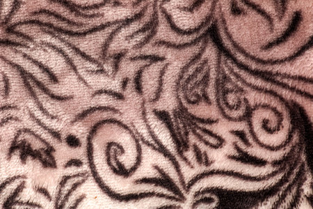 Close-up pattern of fleece fabric with leopard pattern. Brown-beige and black striped repeating on...