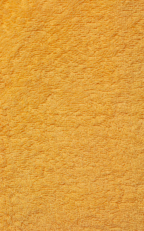 Yellow terry cloth for towels. Yellow fabric and texture concept. Close up terry cloth towel.の写真素材