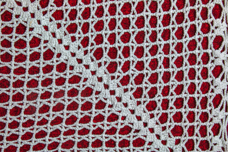Vintage white lace on red background closeup