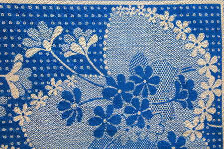 A fragment of the texture of a white-blue tablecloth made in the 1960s in Ukraine. traditional national ornament.の写真素材