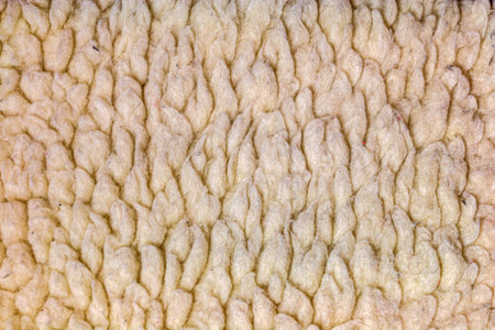 Light brown shaggy fabric. Abstract background of plush faux fur fleece surface close-up.の写真素材