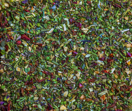 Background of natural green tea with mint, lemon balm, hibiscus and berries. Texture of green tea. Top view, flat lay.の写真素材