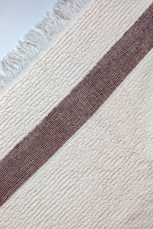 The texture of a light beige with a brown stripe bath towel with a large volumeの写真素材
