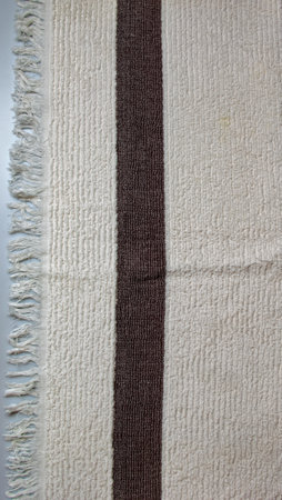 The texture of a light beige with a brown stripe bath towel with a large volumeの写真素材