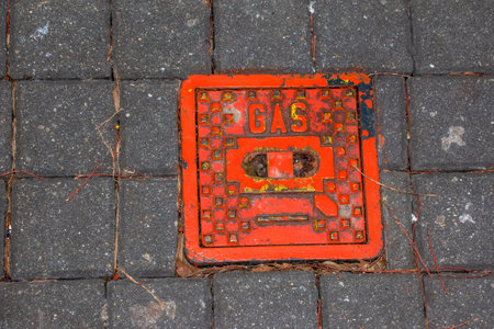 Manhole cover of the gas pipeline system. A massive metal hatch for access to city communications in the pavement.の写真素材