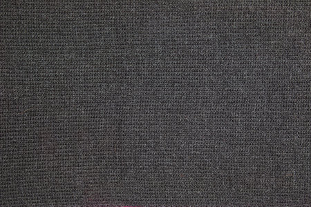 Black knitted fabric texture. Abstract modern Knit texture black color. Dark knitted backgroundの写真素材