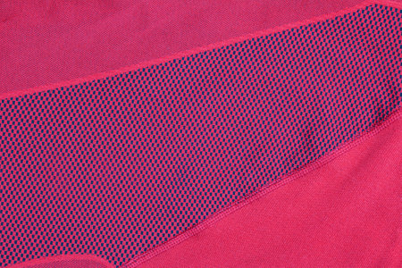 Synthetic fabric texture, red plaid, beautiful background pattern. Fragment of thermal underwear fabric.の写真素材