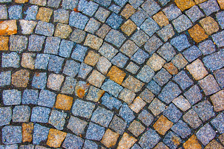 Background of stone pavement. Pavement made of grit stone blocks.の写真素材