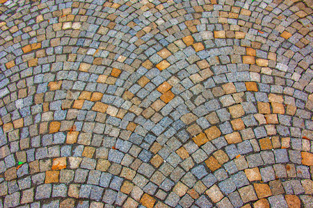 Background of stone pavement. Pavement made of grit stone blocks.の写真素材