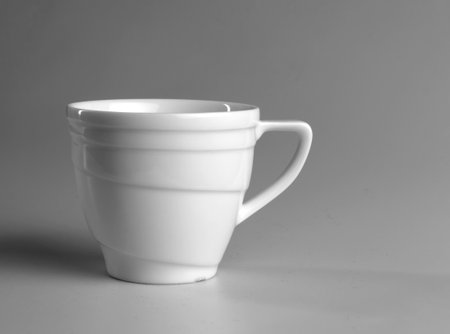 White mug on a gray background. side view.の写真素材