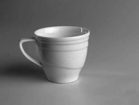 White mug on a gray background. side view.の写真素材