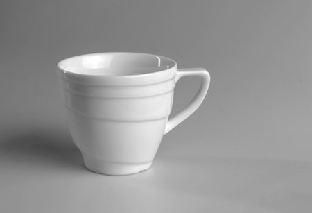 White mug on a gray background. side view.の写真素材