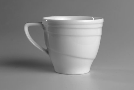 White mug on a gray background. side view.の写真素材