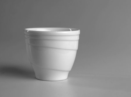 White mug on a gray background. side view.の写真素材