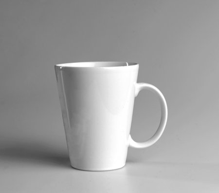 White mug on a gray background. side view.の写真素材