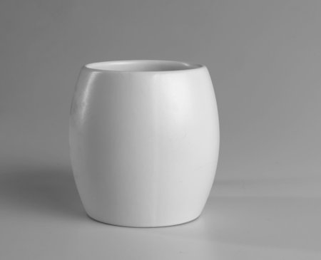 White cup on a gray background. side view.の写真素材