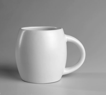 White cup on a gray background. side view.の写真素材