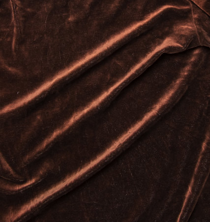 Background of brown velor fabric. Modern upholstered velvet furniture. Creative vintage background.の写真素材