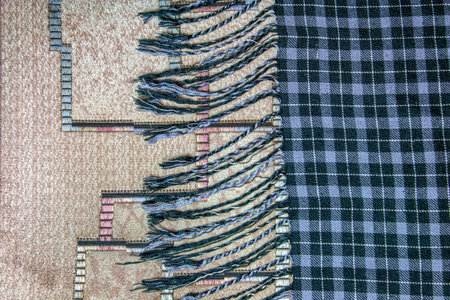 Texture of checkered white, blue wool. Fringed hem. Checkered blue and white textured fabric background closeupの写真素材