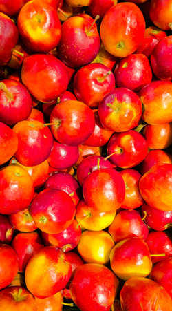 Background of ripe fresh red apples at the food market. top view.の写真素材