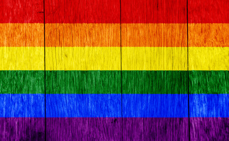 Flag of the LGBT community on the background of the wooden texture of the boards. Rainbow gay culture symbol. concept collage. Illustration symbol of pride.の写真素材