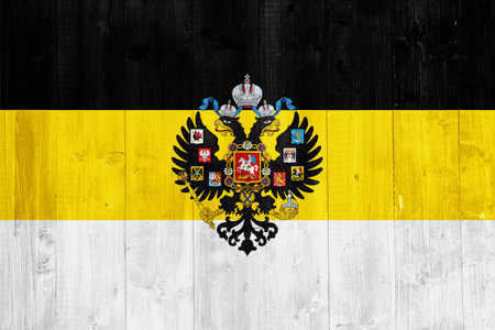 Russian imperial flag with a double-headed eagle. The first official State flag of the Russian Empire and the Flag for celebrations on the texture. concept collage.の写真素材
