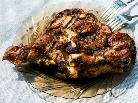 Freshly grilled piece of marinated pork neck on a plate.の写真素材