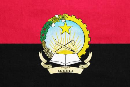 Flag and coat of arms of Republic of Angola on a textured background. concept collage.の写真素材