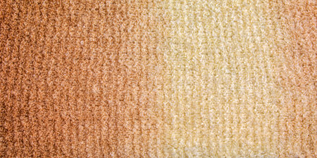 Knitted wool textile with background texture in light beige creamy brown shade. Beige color gradient on texture background. scarf.の写真素材