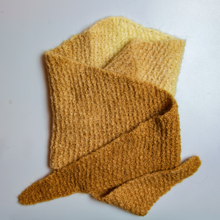 Knitted wool textile with background texture in light beige creamy brown shade. Beige color gradient on texture background. scarf.の写真素材