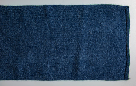 Texture of blue knitted fabric. Abstract modern knitted texture in blue color. Dark knitted backgroundの写真素材