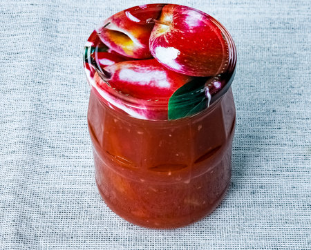 Traditional Hungarian homemade lecho in glass jars. Preserved tomatoes and peppers with spices.の写真素材